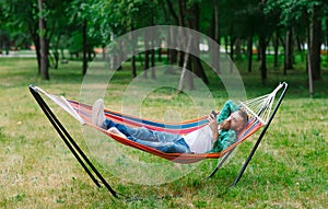The man is lying on a hammock.