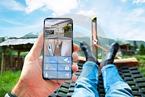 Man Lying In Hammock Watching CCTV Footage