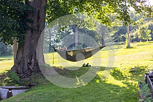 Man lying and resting in a hammock in nature