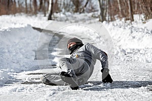 Man lying on the road, downfall and accident on winter season, black ice