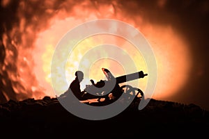 Man with Machine gun at night, fire explosion background or Military silhouettes fighting scene on war fog sky background, World W