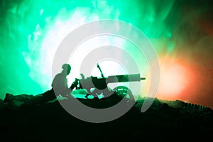 Man with Machine gun at night, fire explosion background or Military silhouettes fighting scene on war fog sky background, World W