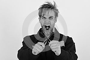 Man with mad face holds wrench tools crossed on white background. Maintenance and repairing concept. Mechanic or plumber