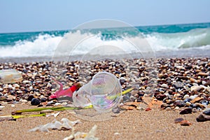 A man-made garbage in the sea: plastic bottles, glasses and other plastic