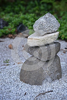 A man-made pile or stack of stones forming a cairn in a Zen garden.  