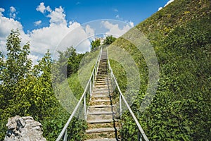 Man-made staircase upstairs to the hill with green grass, travel and tourism concept