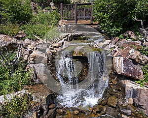 Man made waterfalls over rocks in the Betty Ford Alpine Gardens in Vail, Colorado.