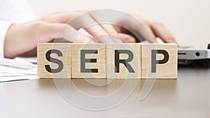 man made word SERP with wood blocks on the background of the office table. selective focus. business concept.