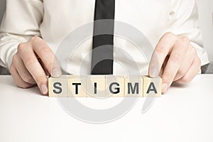 Man made word STIGMA with wood blocks photo
