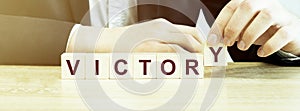 Man made word VICTORY with wood blocks