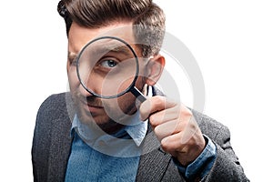 Man with magnifying glass on white background