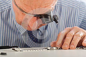 Man with Magnifying Glasses Fixing Watch