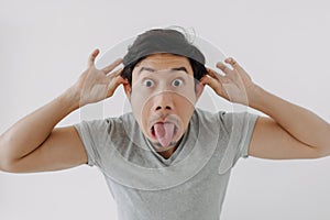Man make funny teasing face for humor isolated on white.
