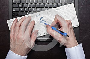 Man makes calendar entry doctor appointment