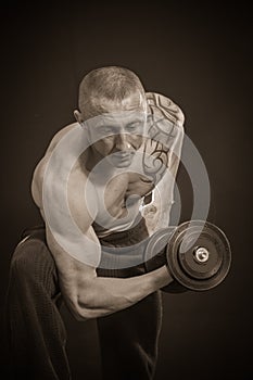 Man makes exercises dumbbells