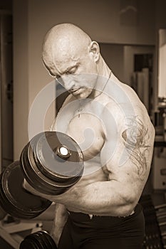 Man makes exercises dumbbells