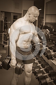 Man makes exercises dumbbells