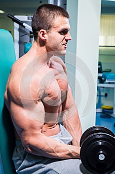 Man makes exercises dumbbells