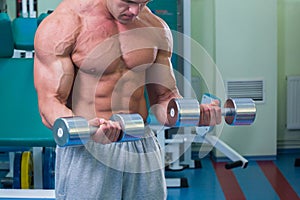 Man makes exercises dumbbells