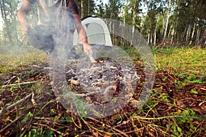 Man with makes fire, active outdoor recreation