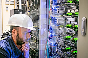 A man makes an important decision on the hosting site of the Internet provider. The engineer thinks how to properly connect the