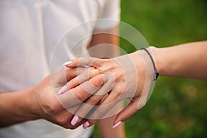 Man makes a marrige proposal to a girl. Gives her a ring for the engagement. Close-up hands