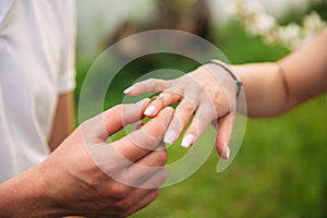 Man makes a marrige proposal to a girl. Gives her a ring for the engagement. Close-up hands