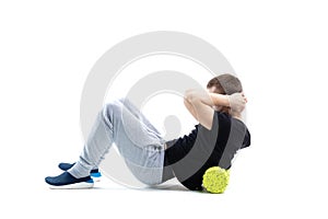 A man makes strengthening exercises for the body with special sports equipment. Self massage increases the body`s tone