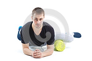 A man makes strengthening exercises for the body with special sports equipment. Self massage increases the body`s tone