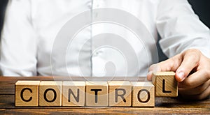 Man makes up the word Controls. Business and process management concept. Control Monitoring compliance with rules photo