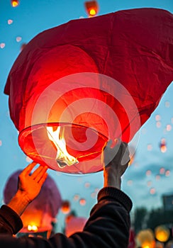Man makes a wish and launches red paper lantern