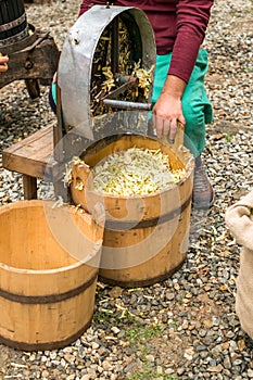 Man is making apple juice using the Apple crushing machine photo