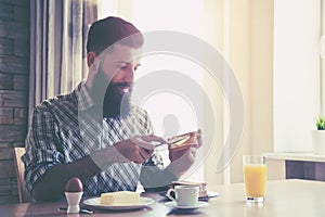 man making breakfast with cup of coffee and toasts