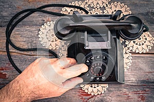 Man making a call on a rotary telephone