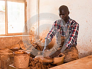 Man making ceramics on pottery wheel