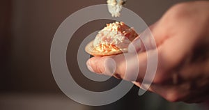 Man making chesse canapes