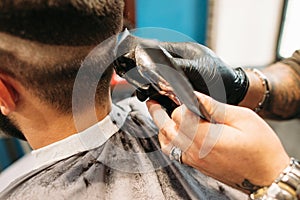 Man making curly haircut at barber shop closeup