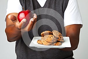 Man making decisions of eating healthy verses unhealthy.