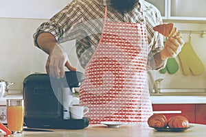 man making espresso with coffee machine while breakfast