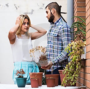 Man making excuses for not watering girlfriends flowers