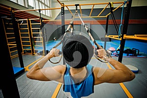 Man making exercises on the uneven bars in the gym