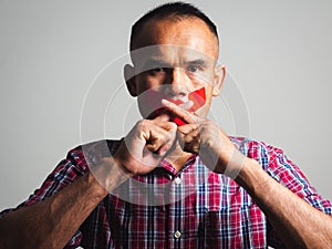 The man making finger on lips silence gesture, pst, shh