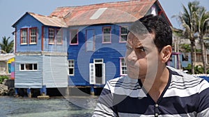 Man Making Funny Face And Old House