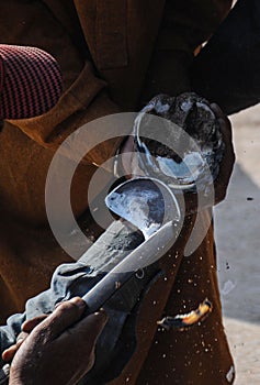 A man is making horseshoes