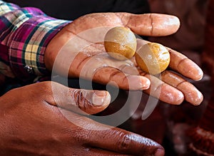 Man making Indian sweet peda or para outside the temple