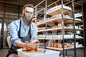 Man making jugs on the pottery wheel