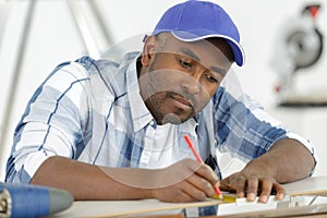 man making mark with carpenter pencil