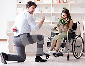 Man making marriage proposal to disabled woman on wheelchair