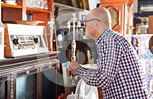 Man making notes in antique store