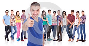 Man making the ok thumbs up gesture in front of his firends